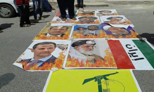 محتجون يحرقون صور روحاني وبشار ونصر الله في الأردن